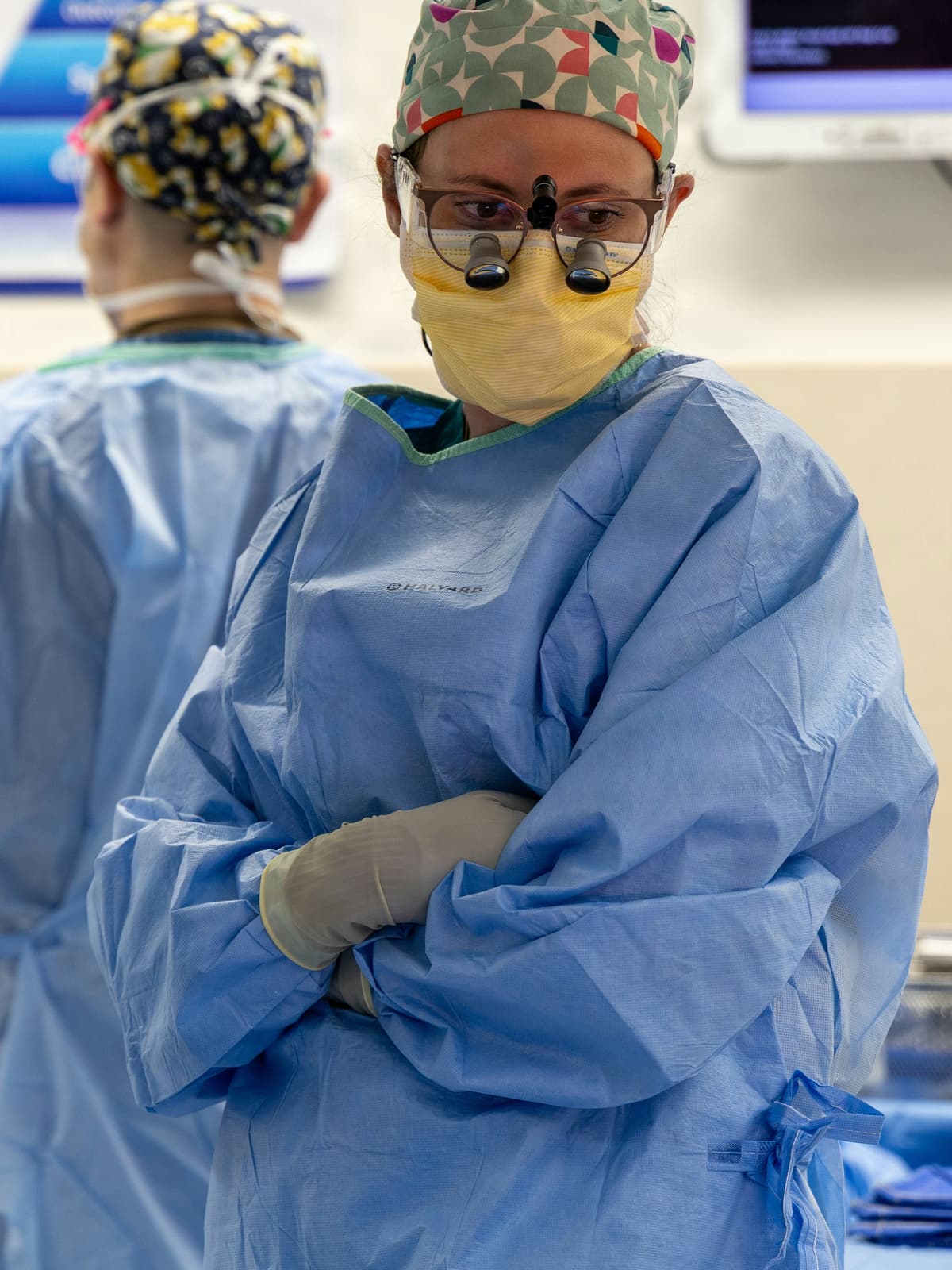 A surgeon in sterile gown and gloves preparing in the operating room